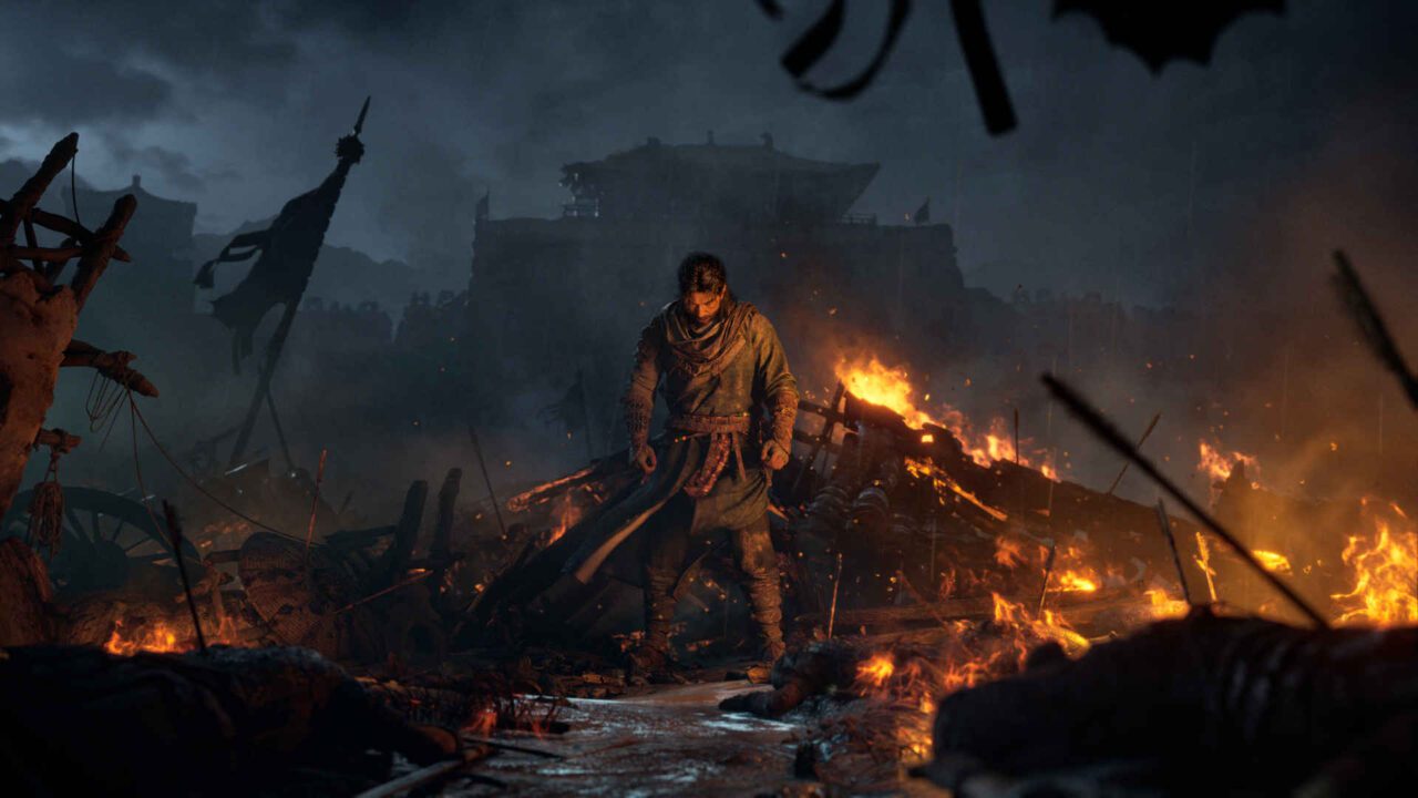 O herói sem nome em destaque em uma cidade destruída por chamas